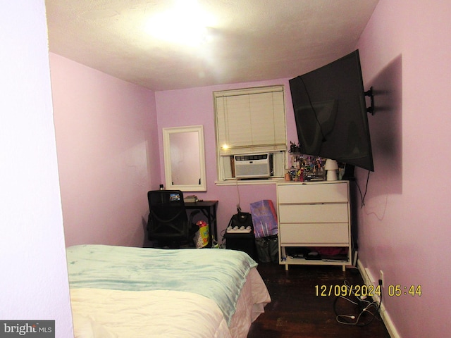 bedroom featuring hardwood / wood-style floors and cooling unit