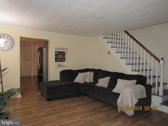 living room with crown molding and dark wood-type flooring