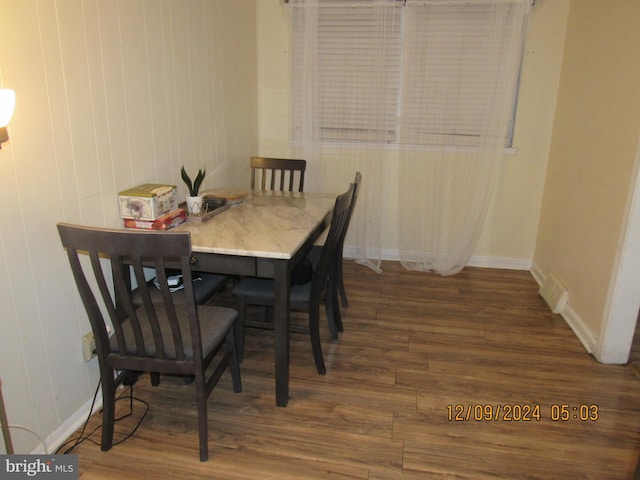 dining area with dark hardwood / wood-style flooring