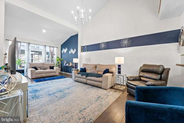 living room featuring a notable chandelier, vaulted ceiling, and hardwood / wood-style flooring