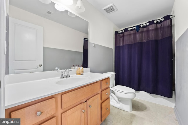 full bathroom with tile patterned flooring, shower / tub combo, vanity, and toilet