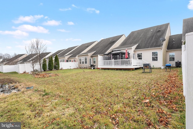 back of house with central AC unit, a deck, and a yard