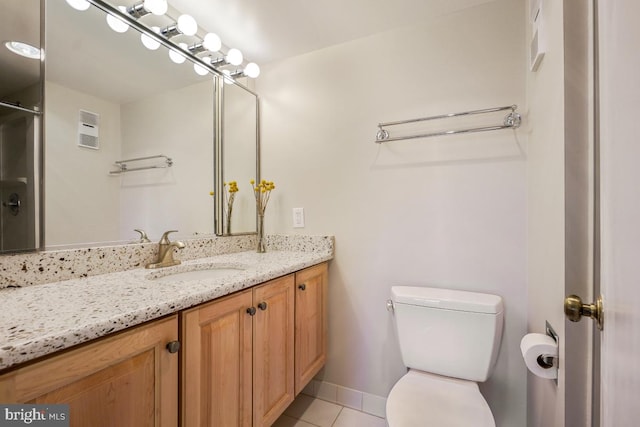 bathroom featuring baseboards, visible vents, toilet, tile patterned floors, and vanity