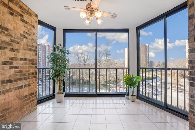 unfurnished sunroom featuring ceiling fan