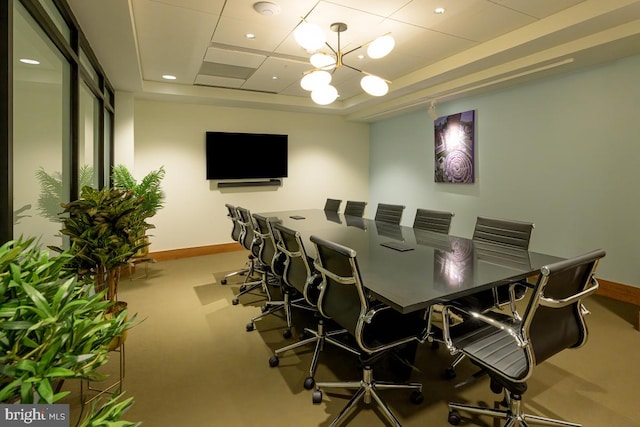 carpeted dining room featuring a chandelier, recessed lighting, a raised ceiling, and baseboards