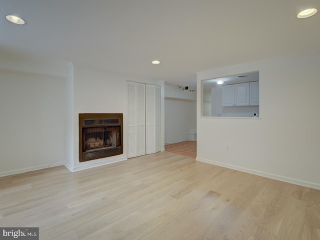 unfurnished living room featuring light wood-type flooring