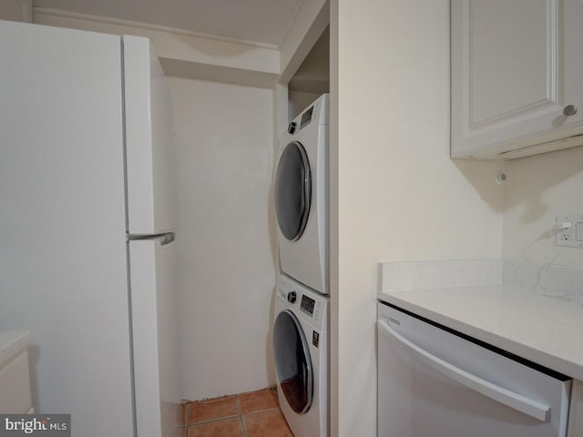 laundry room with light tile patterned floors and stacked washer and clothes dryer