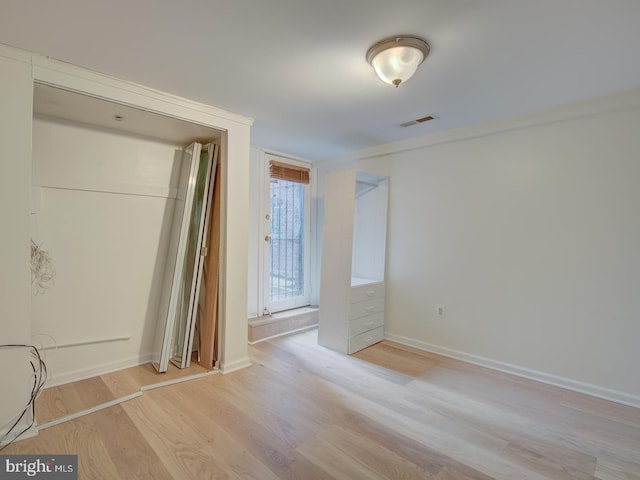 unfurnished bedroom featuring a closet and light hardwood / wood-style flooring