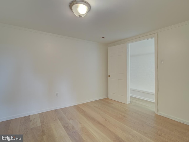 spare room with light hardwood / wood-style flooring and ornamental molding