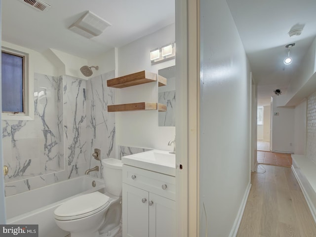 full bathroom with vanity, hardwood / wood-style flooring, toilet, and tiled shower / bath