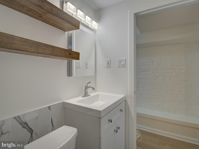 bathroom featuring hardwood / wood-style flooring, vanity, and toilet