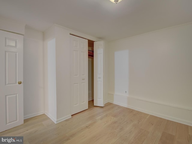 unfurnished bedroom featuring a closet and light hardwood / wood-style flooring