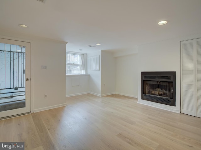 unfurnished living room featuring light wood-type flooring