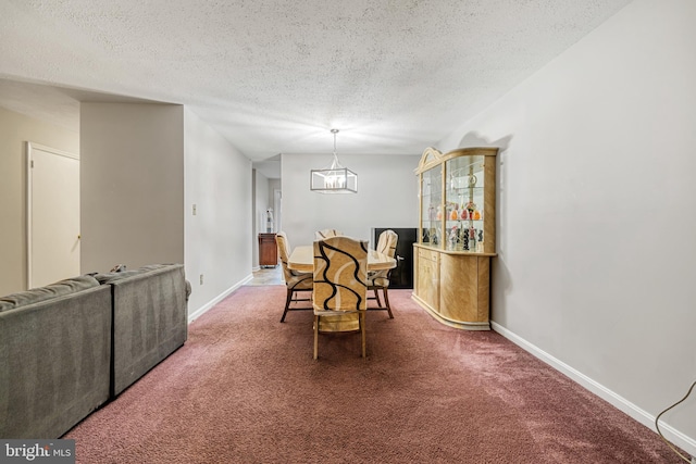 carpeted dining room with a chandelier and a textured ceiling