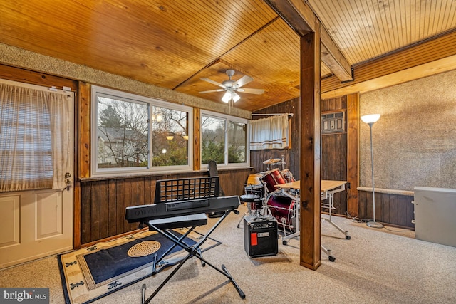 workout room featuring lofted ceiling, wooden ceiling, wooden walls, ceiling fan, and carpet