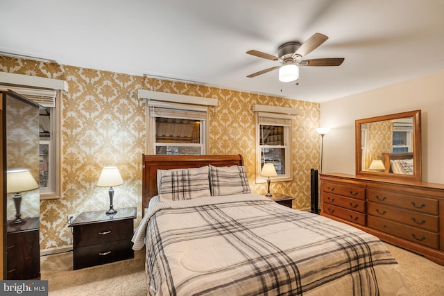 bedroom featuring ceiling fan and light carpet