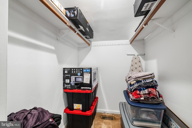 walk in closet with carpet flooring