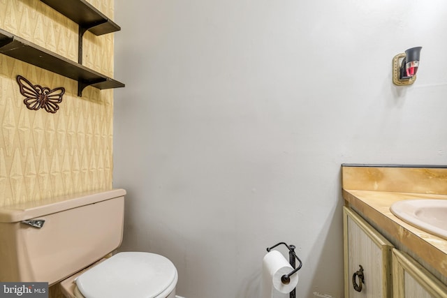 bathroom featuring vanity and toilet