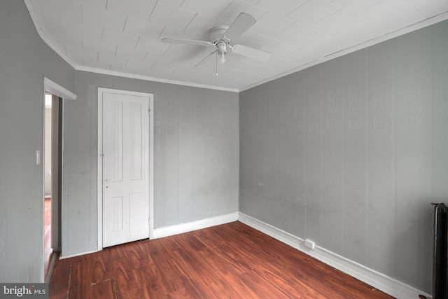 unfurnished bedroom with ceiling fan, dark hardwood / wood-style flooring, and crown molding