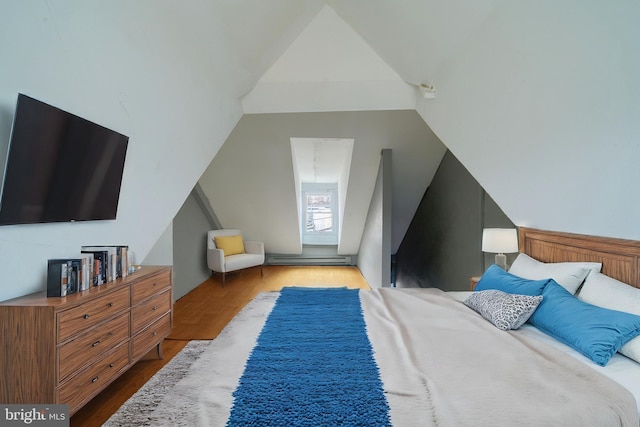 bedroom featuring light hardwood / wood-style flooring and lofted ceiling