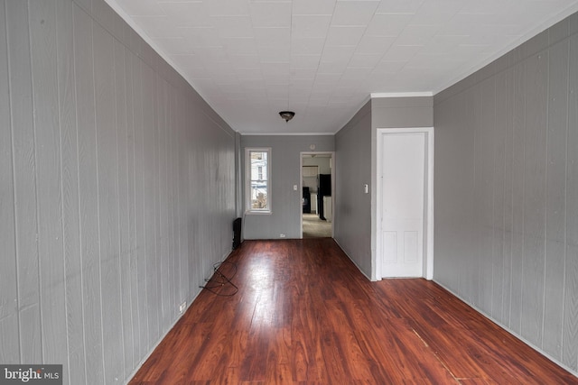 interior space with ornamental molding and dark wood-type flooring