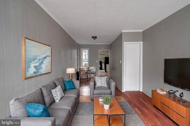 living room with crown molding and dark hardwood / wood-style flooring