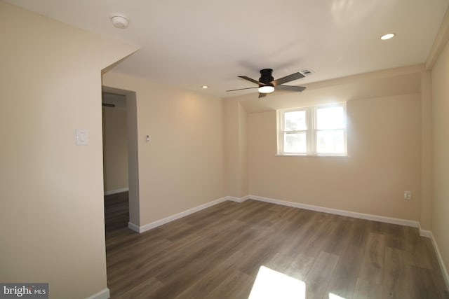 unfurnished room featuring ceiling fan and dark wood-type flooring