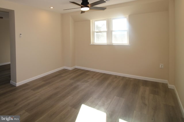 empty room featuring ceiling fan and dark hardwood / wood-style floors