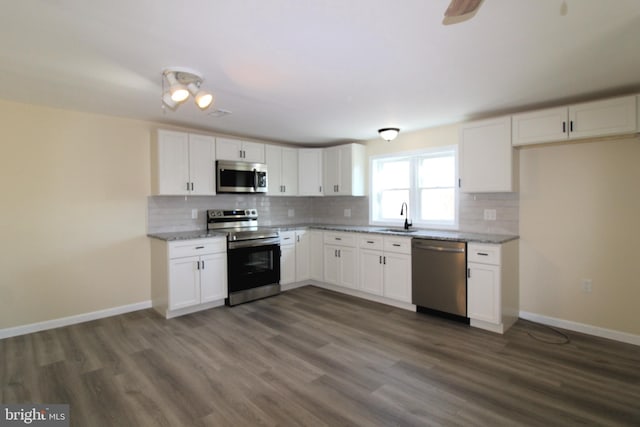 kitchen featuring dark hardwood / wood-style floors, white cabinetry, sink, and appliances with stainless steel finishes