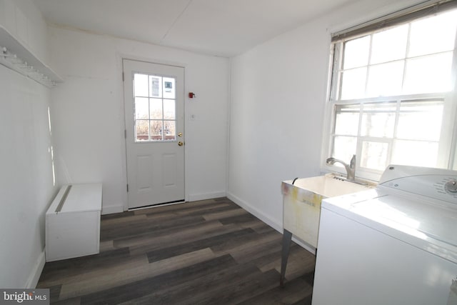 laundry room with dark hardwood / wood-style flooring, sink, and washer / clothes dryer