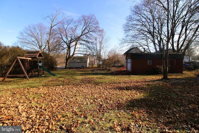 view of yard featuring an outdoor structure and a playground