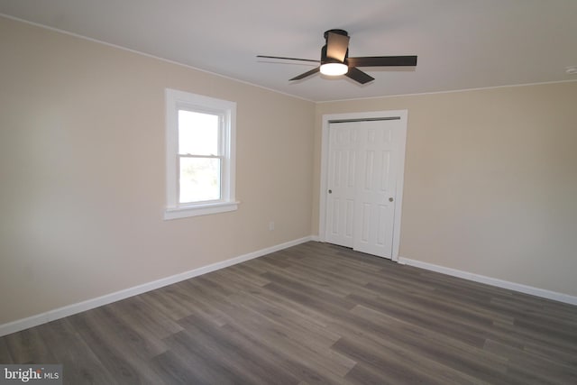 unfurnished room with ceiling fan and dark hardwood / wood-style flooring