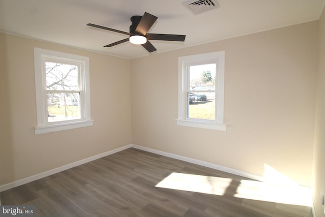 unfurnished room featuring ceiling fan and dark wood-type flooring