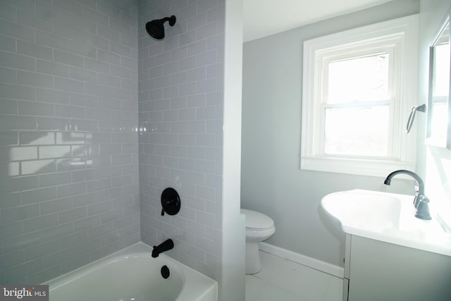 full bathroom with tile patterned flooring, toilet, vanity, and tiled shower / bath