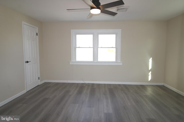 unfurnished room with ceiling fan and dark wood-type flooring