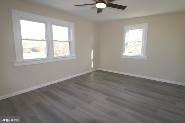 empty room featuring ceiling fan and dark wood-type flooring