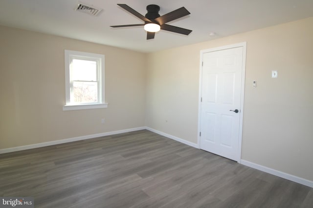 unfurnished room featuring ceiling fan and dark hardwood / wood-style floors