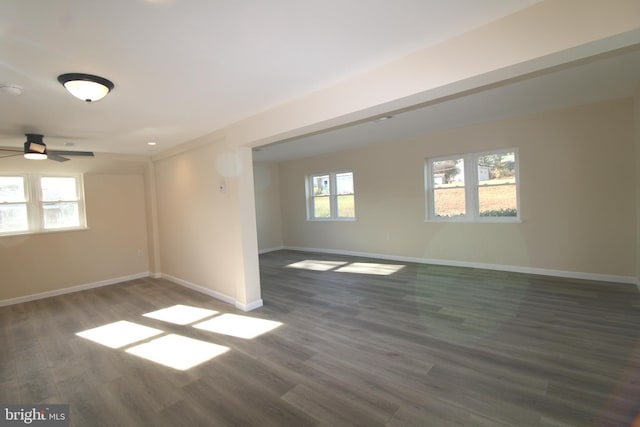 empty room with dark hardwood / wood-style flooring and ceiling fan