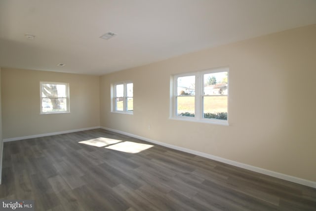 empty room featuring dark wood-type flooring