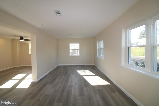 spare room featuring dark hardwood / wood-style flooring and ceiling fan