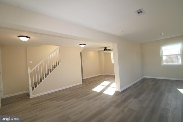 unfurnished room with ceiling fan and dark hardwood / wood-style flooring