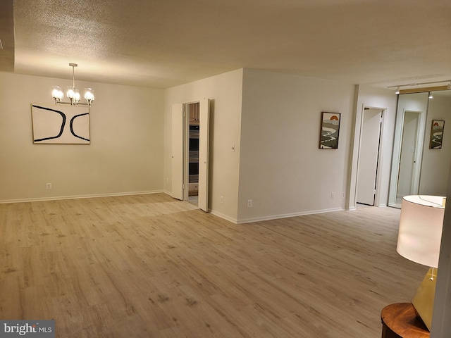8340 Greensboro Dr Unit 1010, Mclean, VA 22102 - empty room with light wood-style floors and a chandelier