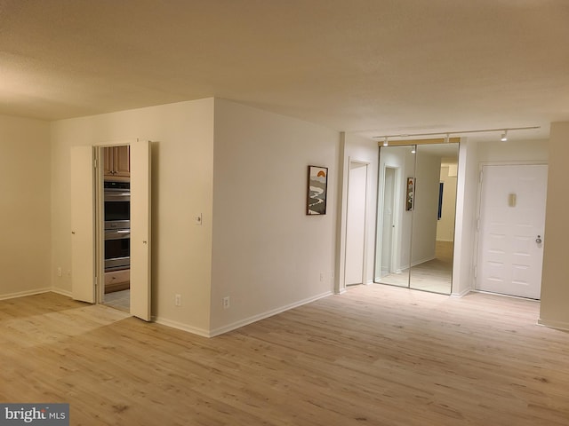 empty room with light hardwood / wood-style floors