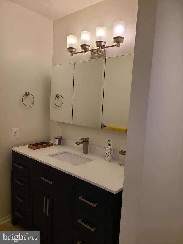 bathroom with vanity and a textured ceiling