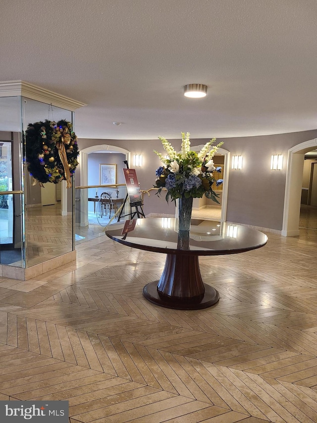 details featuring parquet floors and a textured ceiling