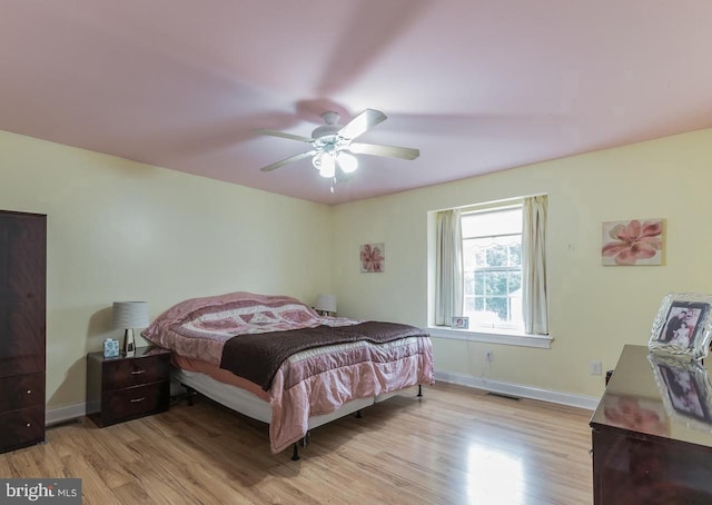 bedroom featuring light wood-type flooring and ceiling fan