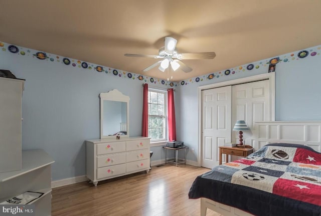 bedroom with ceiling fan, a closet, and wood-type flooring