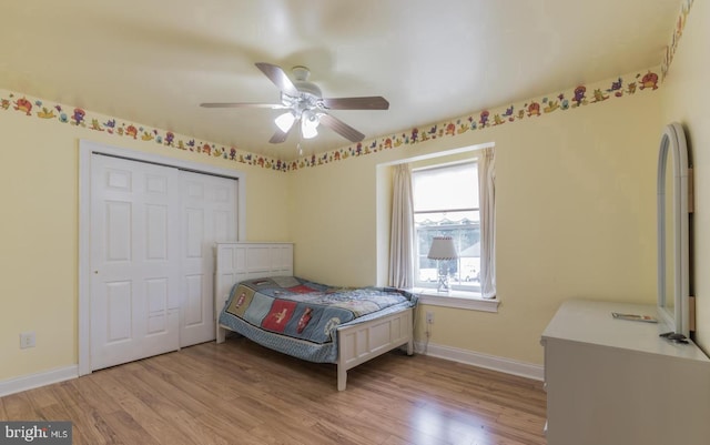 bedroom with ceiling fan, a closet, and light hardwood / wood-style flooring