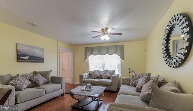 living room featuring ceiling fan and dark hardwood / wood-style floors