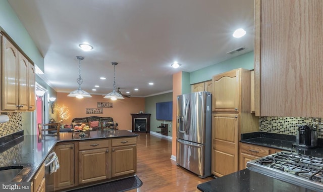 kitchen with backsplash, decorative light fixtures, stainless steel refrigerator with ice dispenser, and light hardwood / wood-style flooring